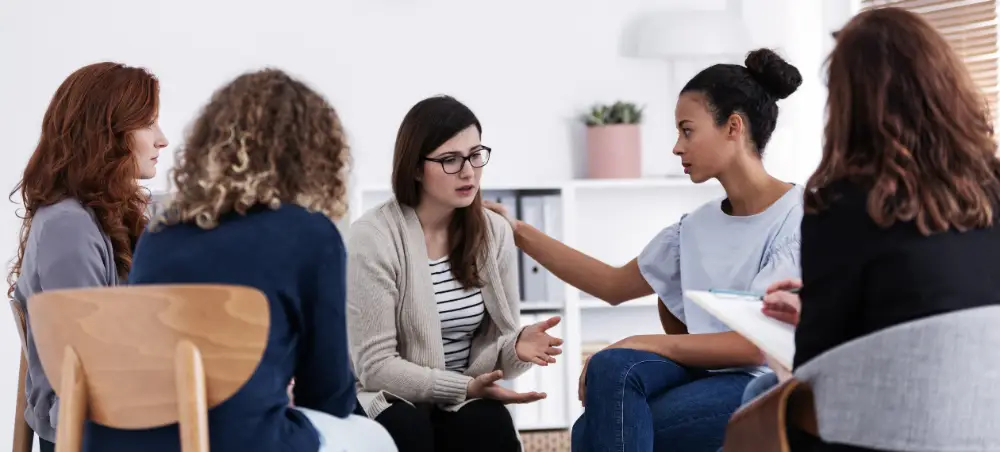 Women supporting each other in a group therapy session at a Lexington, KY addiction treatment center.